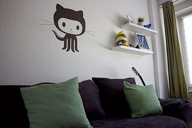 Photo of my office with Github's octocat on the wall over my couch
